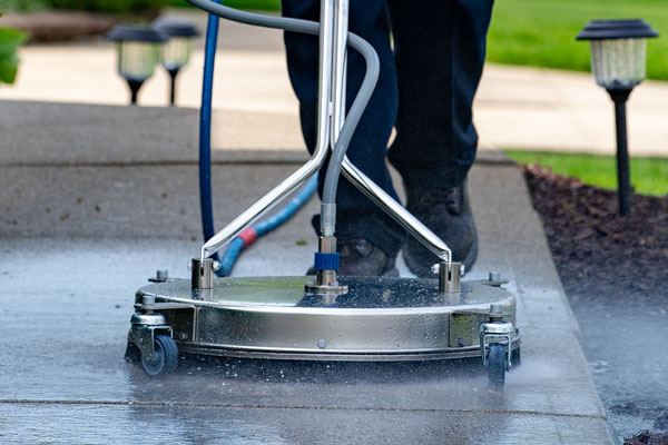 Surface Cleaner Washing a Concrete Walkway