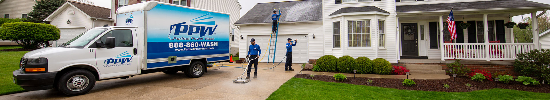 Power Washing Services Being Performed on a House