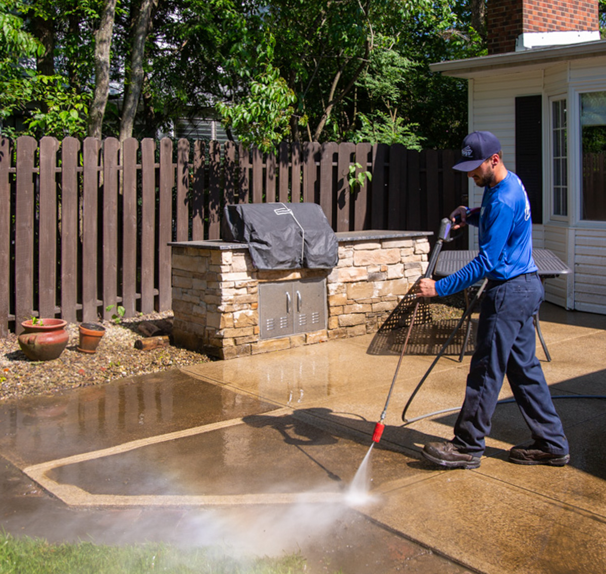Perfect Power Wash technician power washing concrete patio