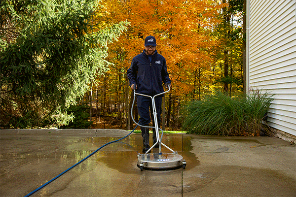 Perfect Power Wash employee surface cleaning a driveway